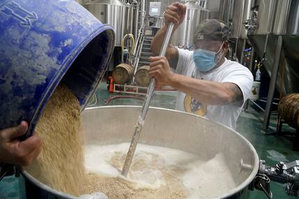 Kuumba Smith mashed the grain for a kettle sour beer at Hop & Sting Brewery in Grapevine in...