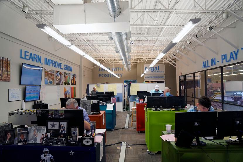 With their core values on the walls above them, sales reps take calls at Regal Plastics.