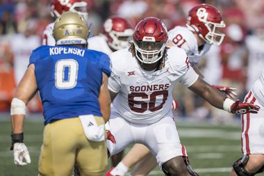 FILE - Oklahoma offensive lineman Tyler Guyton (60) looks to block during the first half of...