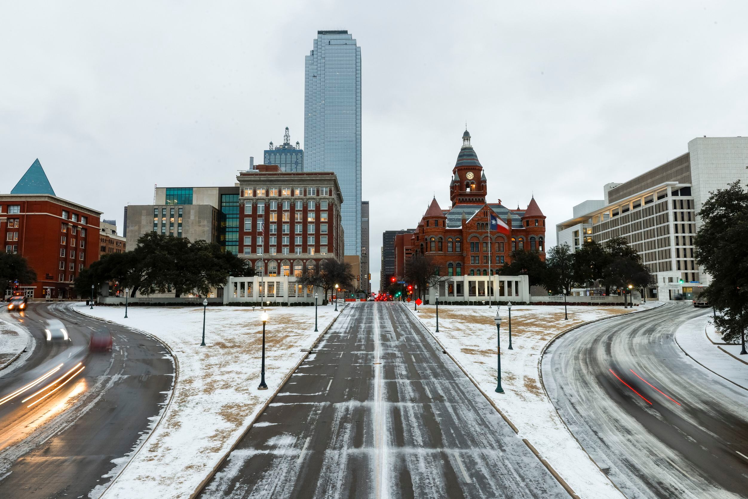 Motorists pass through an icy Dealey Plaza on Thursday, Feb. 3, 2022 in Dallas.