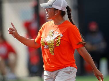 Rockwall head coach Shadie Acosta converses with the plate umpire after a mound visit during...