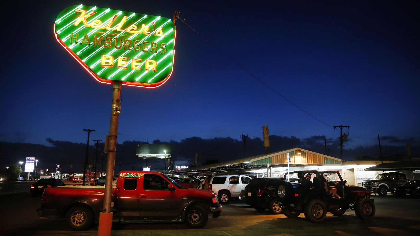 At dusk, the neon sign at Keller's Drive-In glows on Northwest Highway in Dallas, Thursday, May 14, 2020.