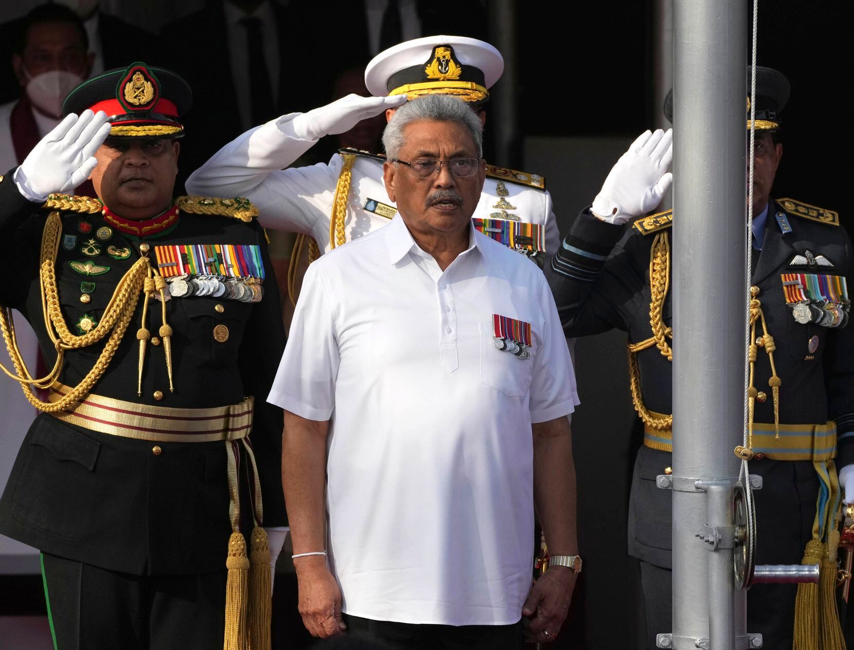 FILE- Sri Lankan President Gotabaya Rajapaksa sings the national anthem of Sri Lanka during...