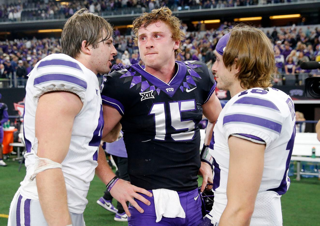TCU Horned Frogs quarterback Max Duggan (15) is consoled by Kansas State Wildcats linebacker...