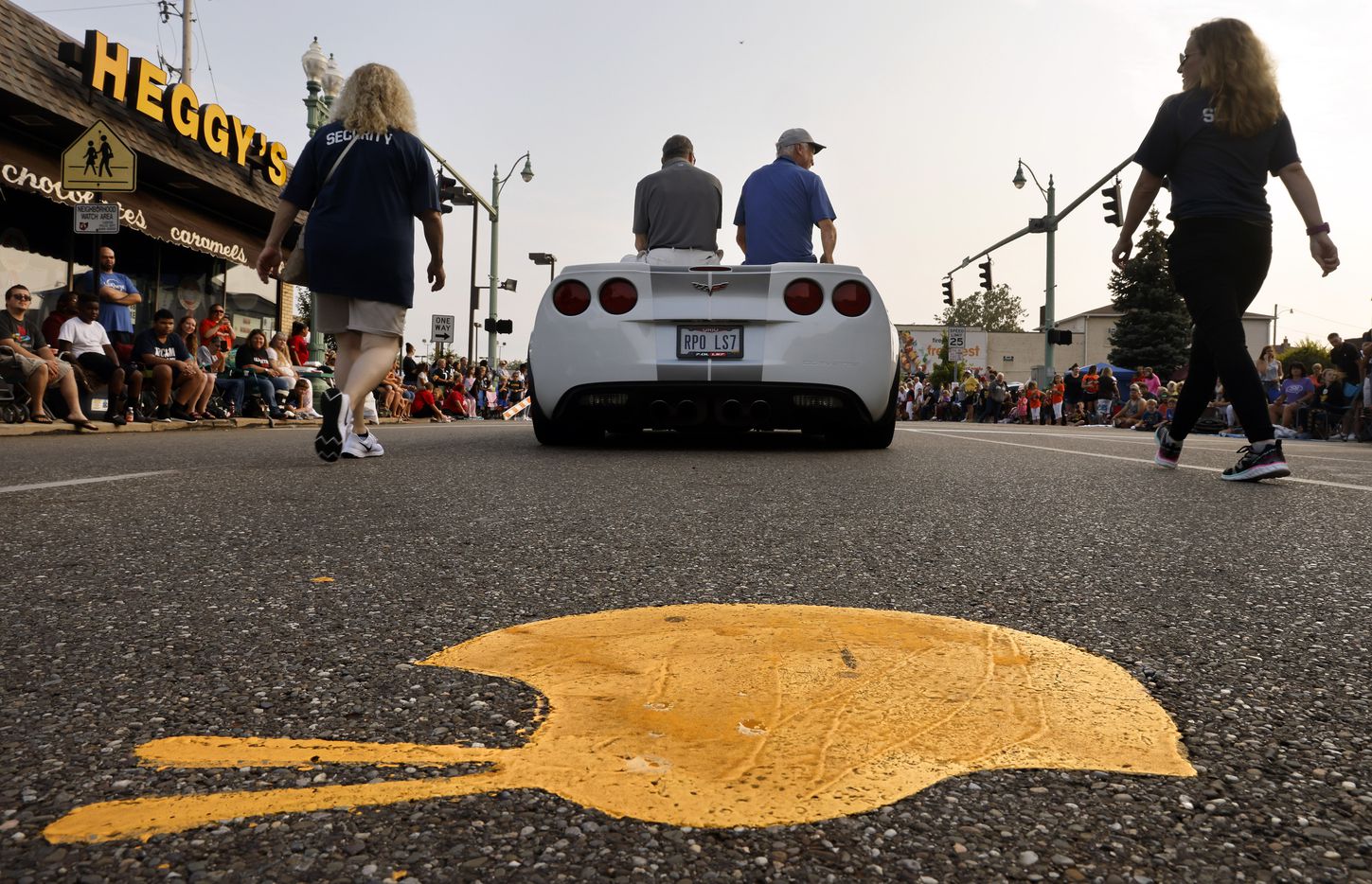 Dallas Cowboys Pro Football Hall of Fame inductee Cliff Harris (right, in car) and former Cowboys safety Charlie Waters follow the gold helmets marking the Canton Repository Grand Parade route in downtown Canton, Ohio, Saturday, August 7, 2021. The parade honored newly elected and former members of the Hall, including newcomers and former Dallas Cowboys players Cliff Harris, Drew Pearson and head coach Jimmy Johnson. (Tom Fox/The Dallas Morning News)