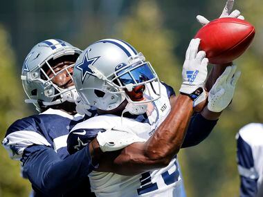 Dallas Cowboys wide receiver Michael Gallup (13) catches a ball as he fights off cornerback...