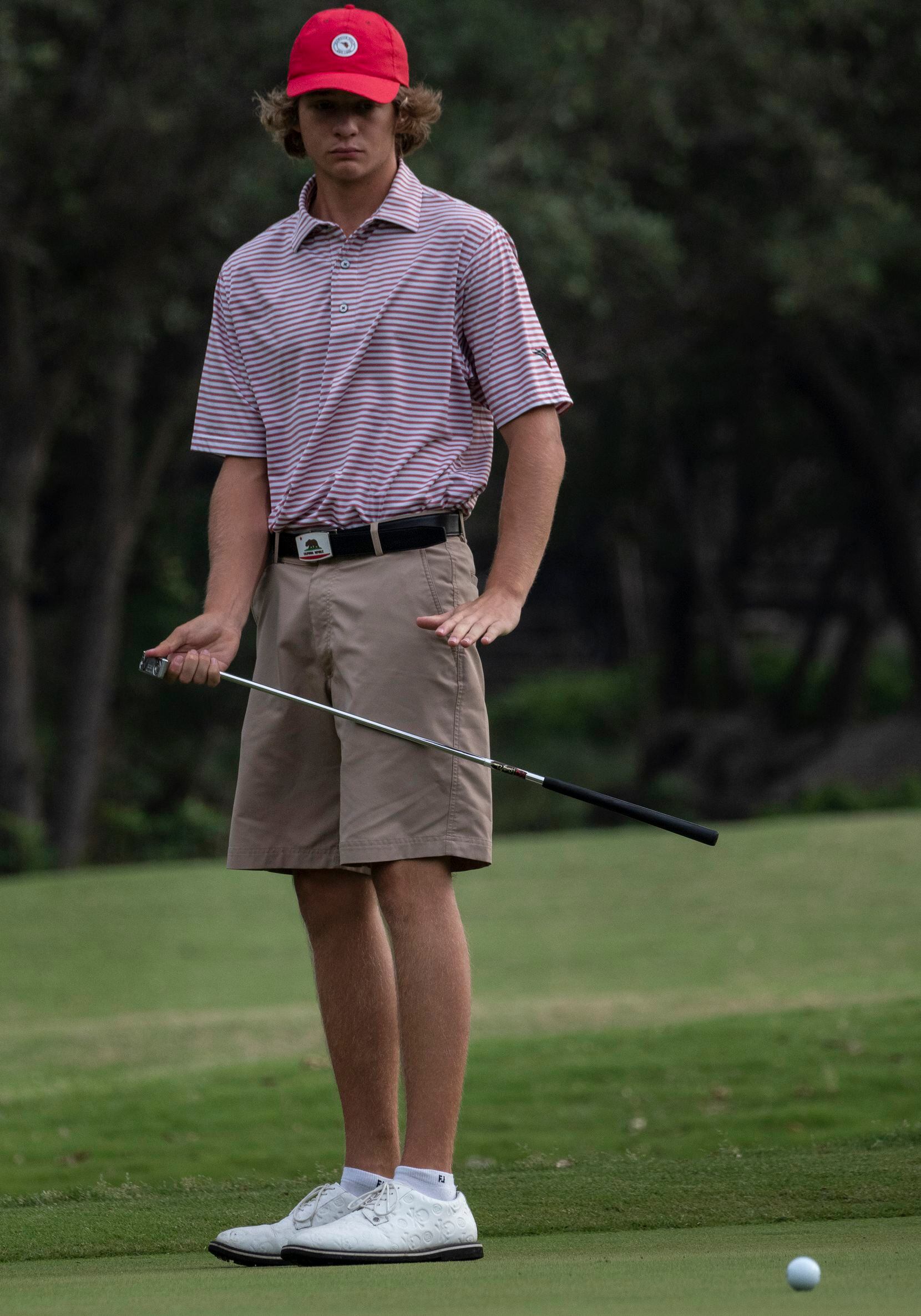 Flower Mound Marcus, Sam Pampling, watches a putt on the no1. green during the first round...