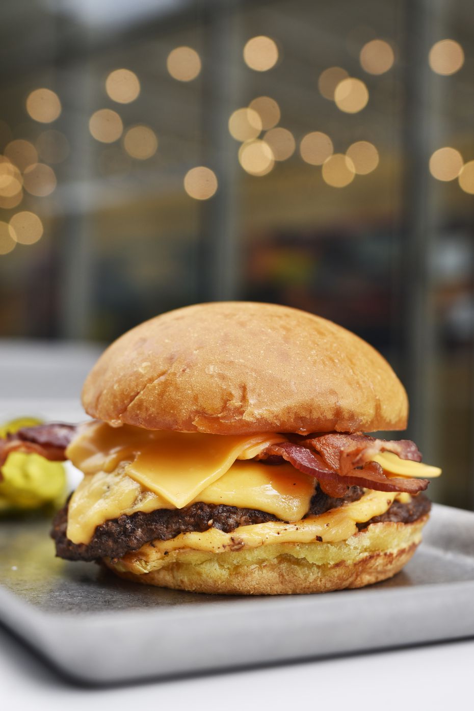 The burger at Ellie's is topped with smoked bacon, cheese and pickles.