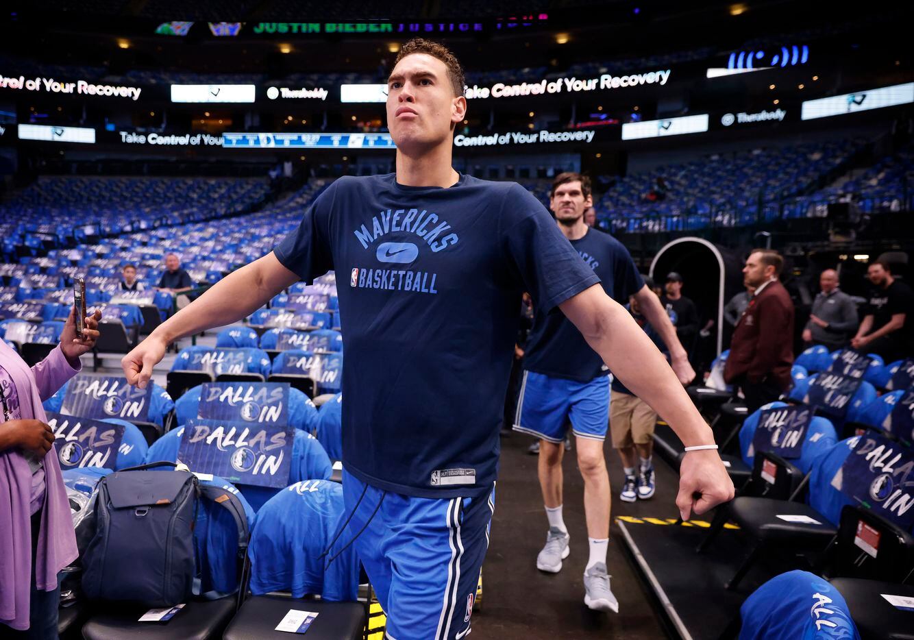 Dallas Mavericks centers Dwight Powell (front) and  center Boban Marjanovic (back) march...