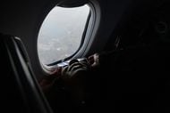 Michelle Lovett of Birmingham, Ala., looks out a window of Southwest flight #1252 from...