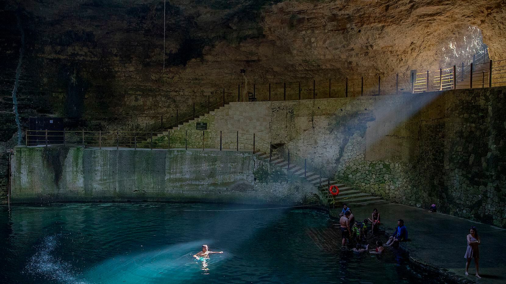 Sunlight shines on the water in Cenote Hubiku. The former Mayan sacred site in Valladolid, Mexico, has a maximum depth of 150 feet.