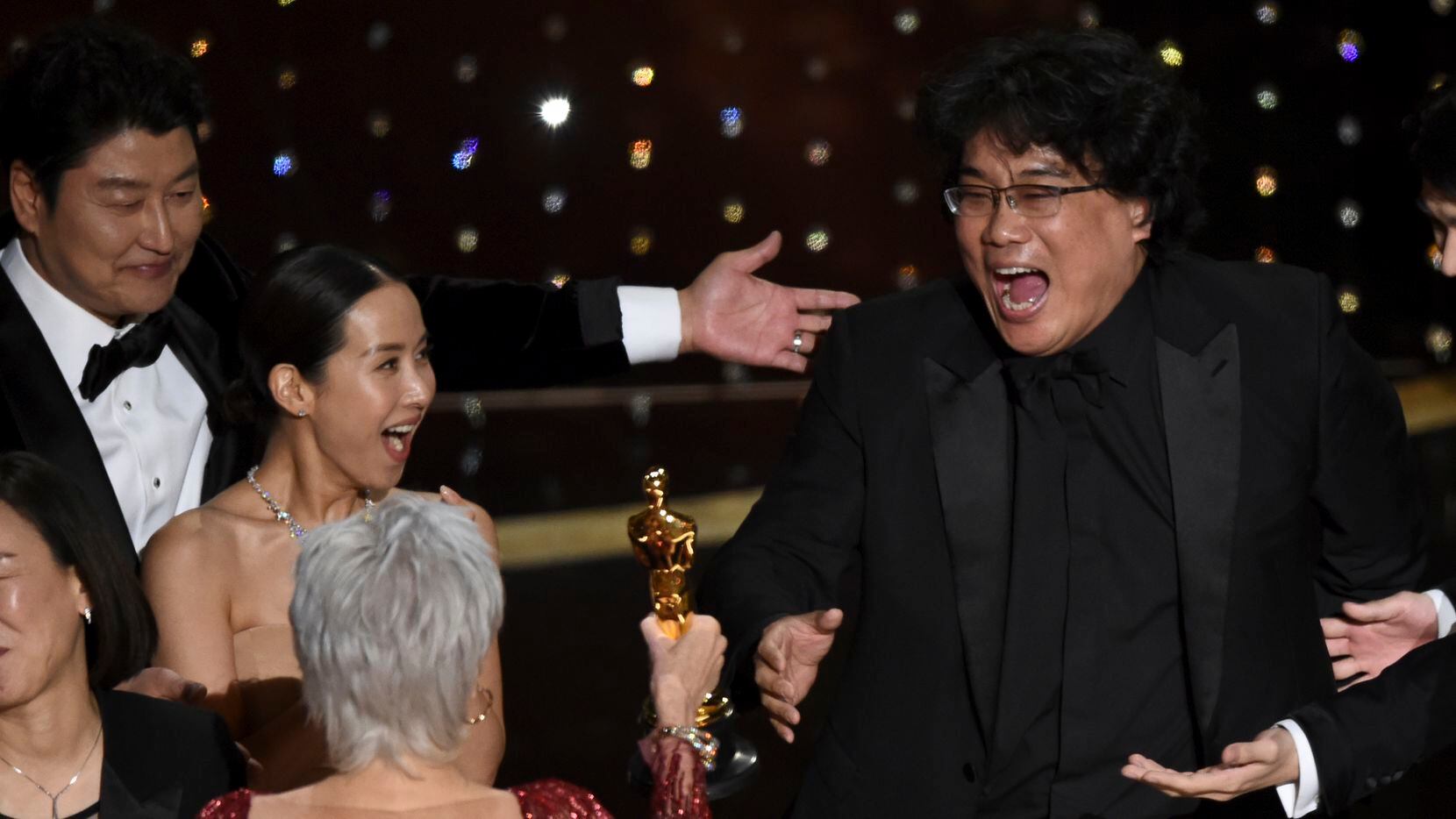 Bong Joon-ho, right, reacts as he is presented with the award for best picture for "Parasite" from presenter Jane Fonda at the Oscars on Sunday, Feb. 9, 2020, at the Dolby Theatre in Los Angeles. Looking on from left are Kang-Ho Song and Kwak Sin Ae.