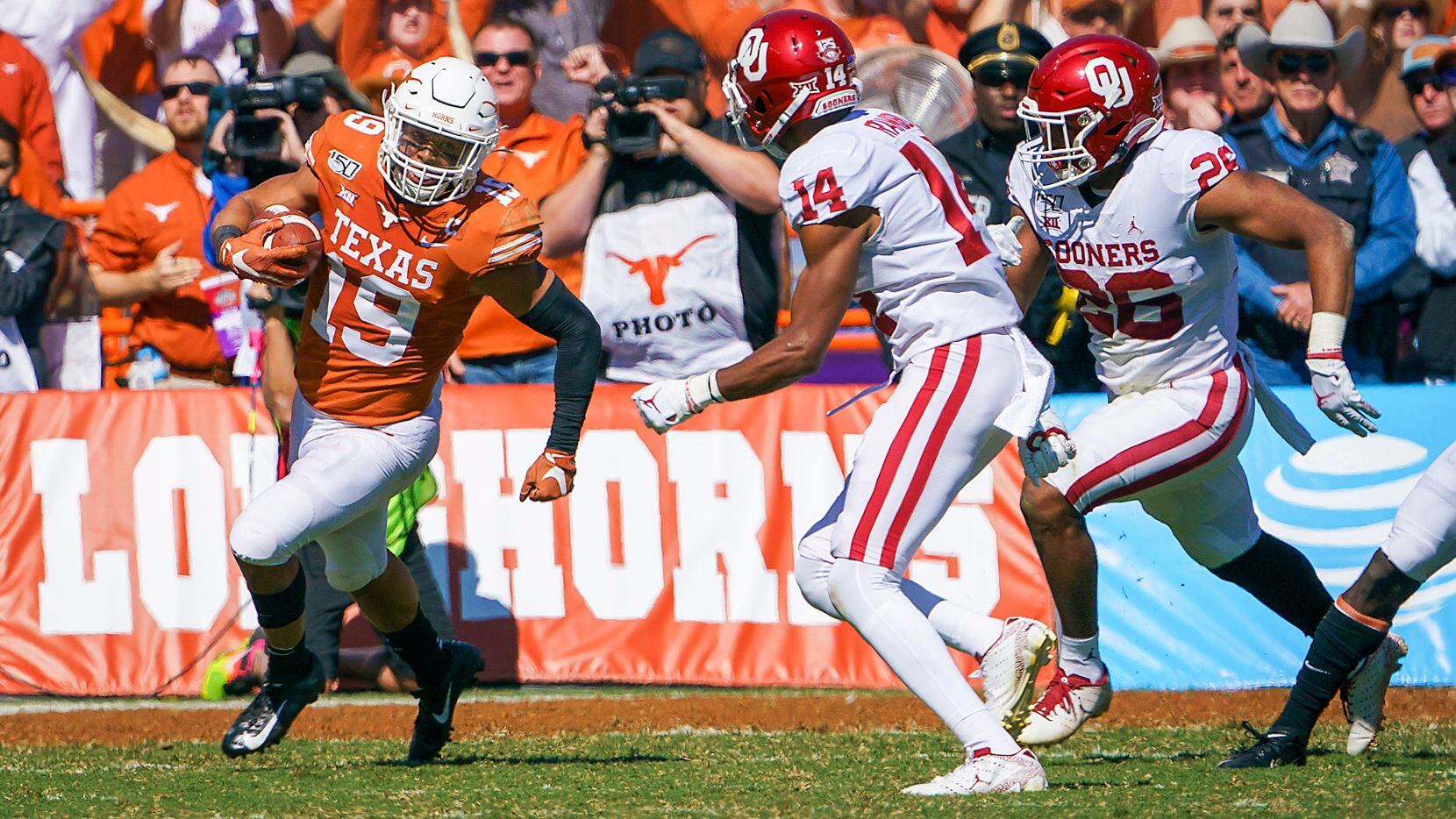 Texas defensive back Brandon Jones (19) returns an interception during the first half of an NCAA football game against Oklahoma at the Cotton Bowl on Saturday, Oct. 12, 2019, in Dallas. 