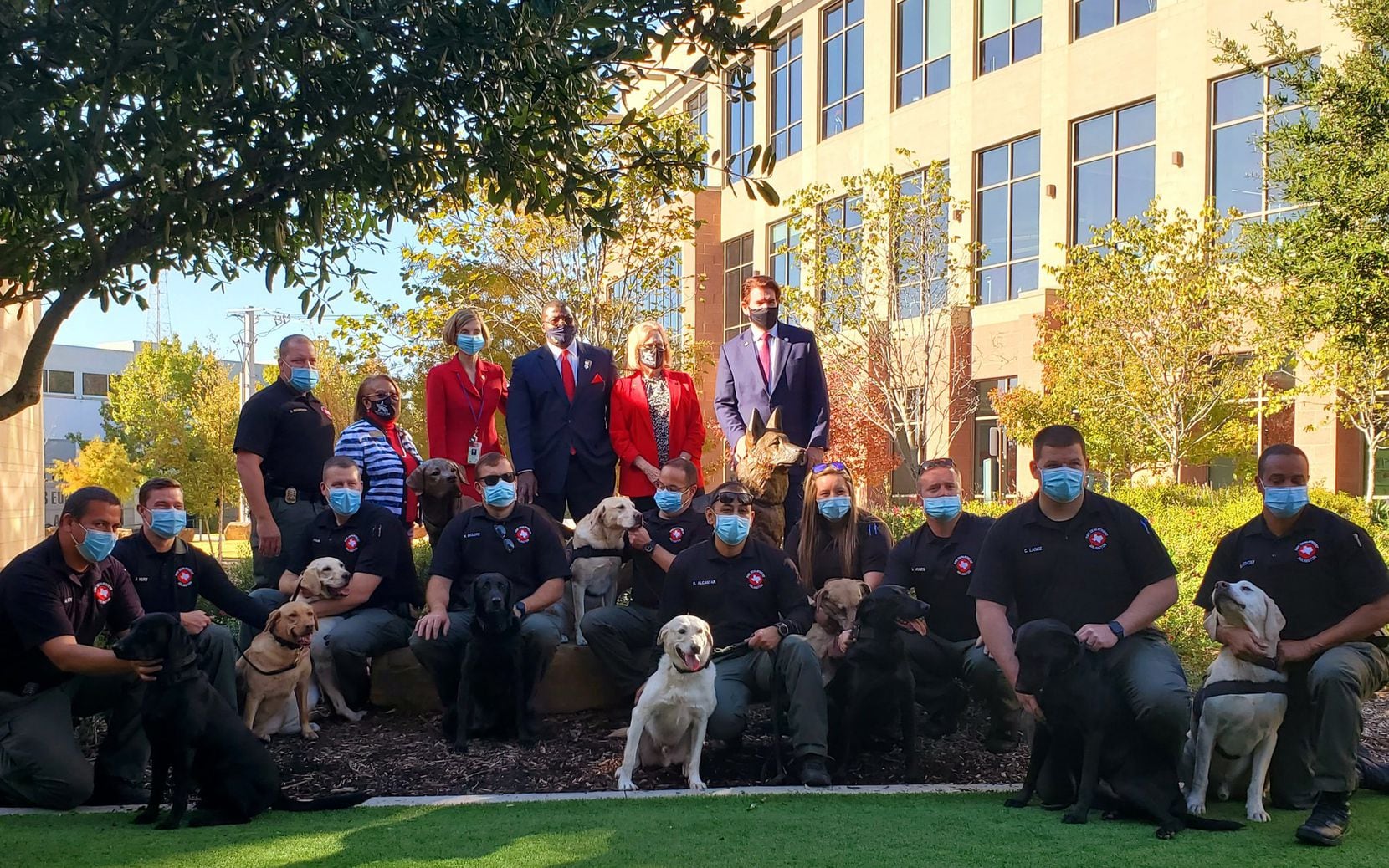 Arlington City Council members along with the city's K9 units pose around the new statue memorializing the city's service dogs. Both the fire and police departments use service dogs in their work.