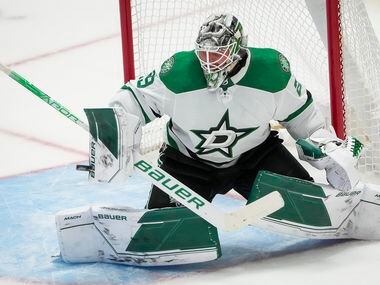 Dallas Stars goaltender Jake Oettinger (29) makes a save during the third period of an NHL...