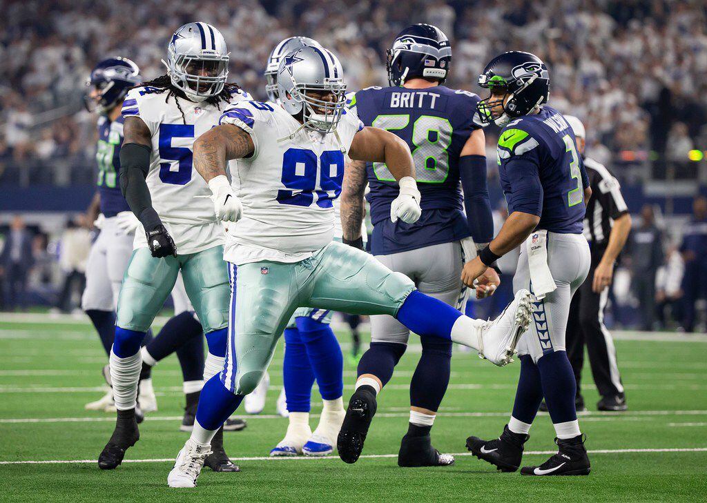 Cowboys defensive tackle Antwaun Woods (99) celebrates after sacking Seattle Seahawks quarterback Russell Wilson (3) during the first half of an NFL wild-card playoff football game at AT&T Stadium on Saturday, Jan. 5, 2019, in Arlington. (Smiley N. Pool/The Dallas Morning News)