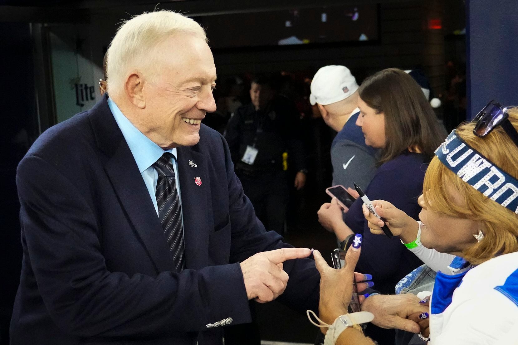 Dallas Cowboys owner and general manager Jerry Jones chats with fan Carolyn Price before an...