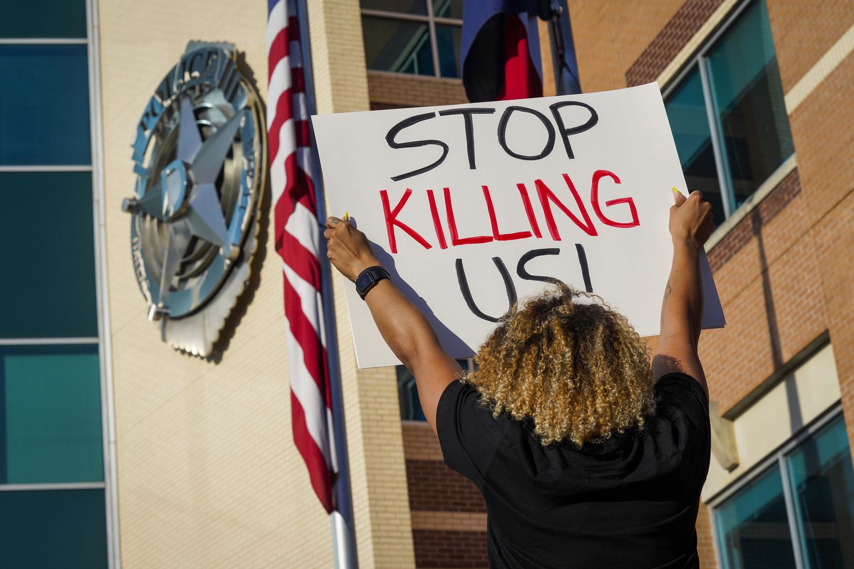 Demonstrators protest against police brutality at the Dallas Police Headquarters on Friday,...