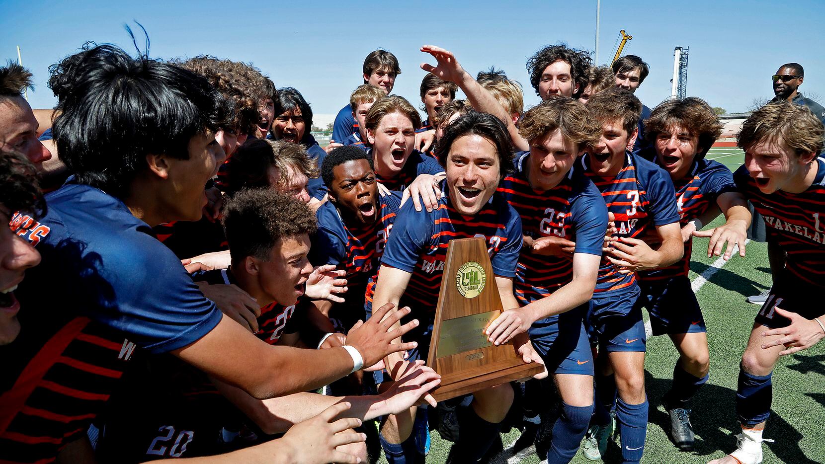 Frisco Wakeland receives the championship trophy after beating Frisco Lone Star in a...