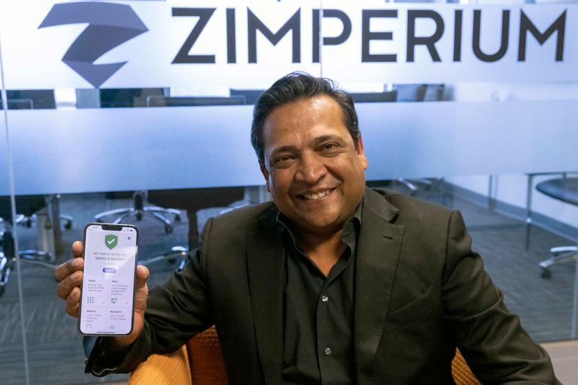 Zimperium CEO Shridhar Mittal holds his phone with the Dallas Secure app at the Zimperium...