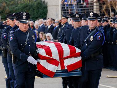 Members of the Mesquite Police Honor Guard carry the coffin of Mesquite police officer...