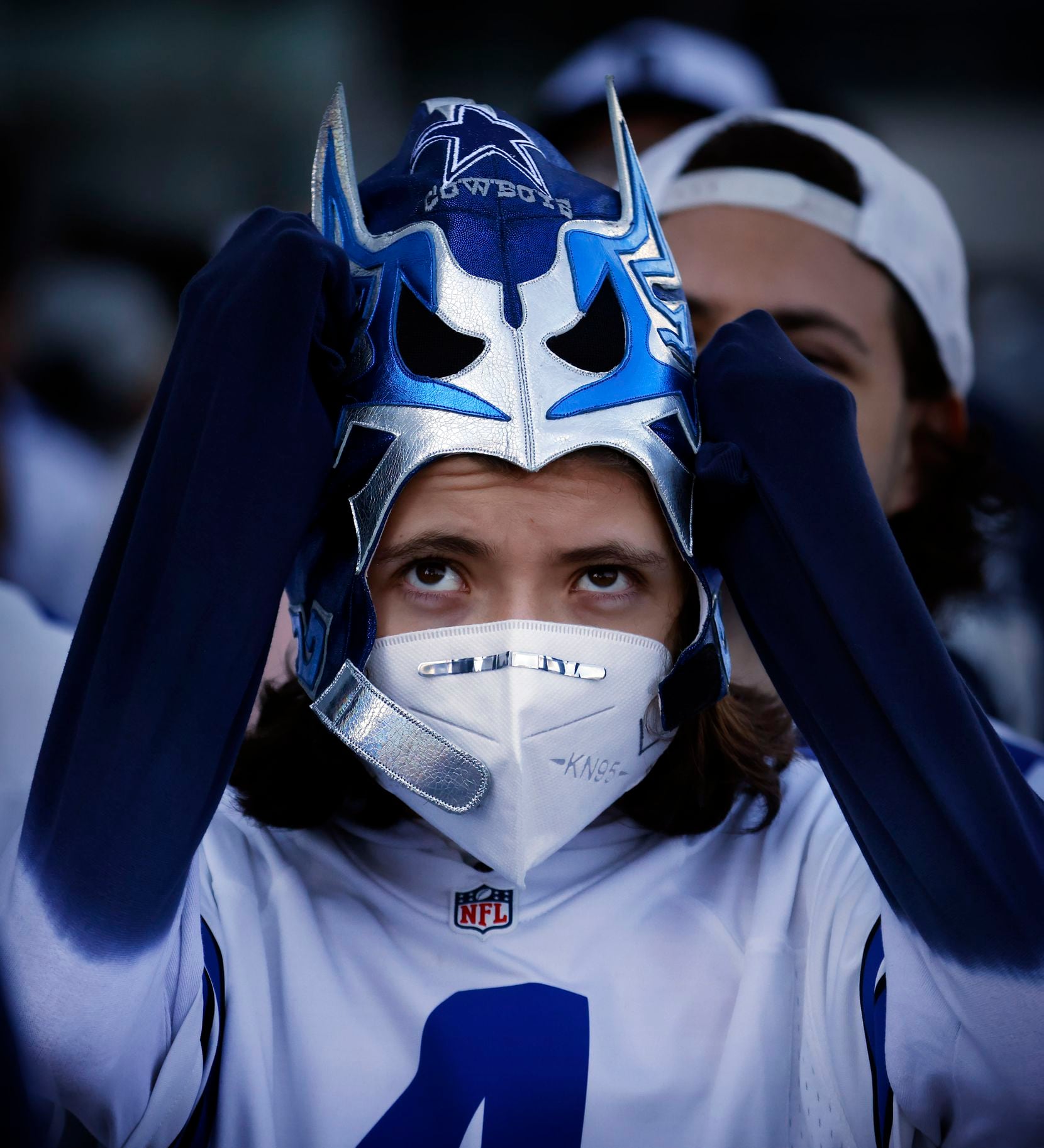 Dallas Cowboys fan Leonardo Saurez, 13, of Mexico City dons his lucha libre mask as fans...