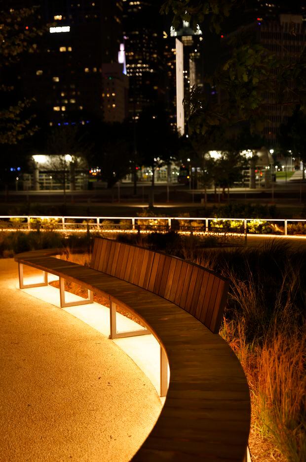 Lights under benches and low rails light up the newly constructed Carpenter Park at night,...