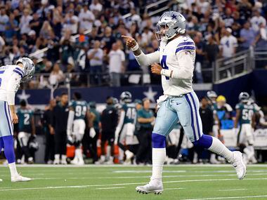 Dallas Cowboys quarterback Dak Prescott (4) runs to the sideline after they scored a first...