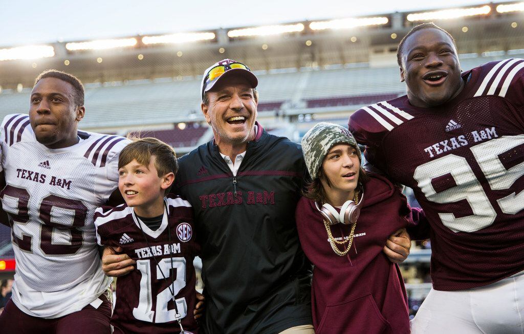 FILE - Texas A&M head coach Jimbo Fisher, center, sings the school song with his team after the Maroon and White spring game on Saturday, April 14, 2018 at Kyle Field in College Station. (Ashley Landis/The Dallas Morning News)