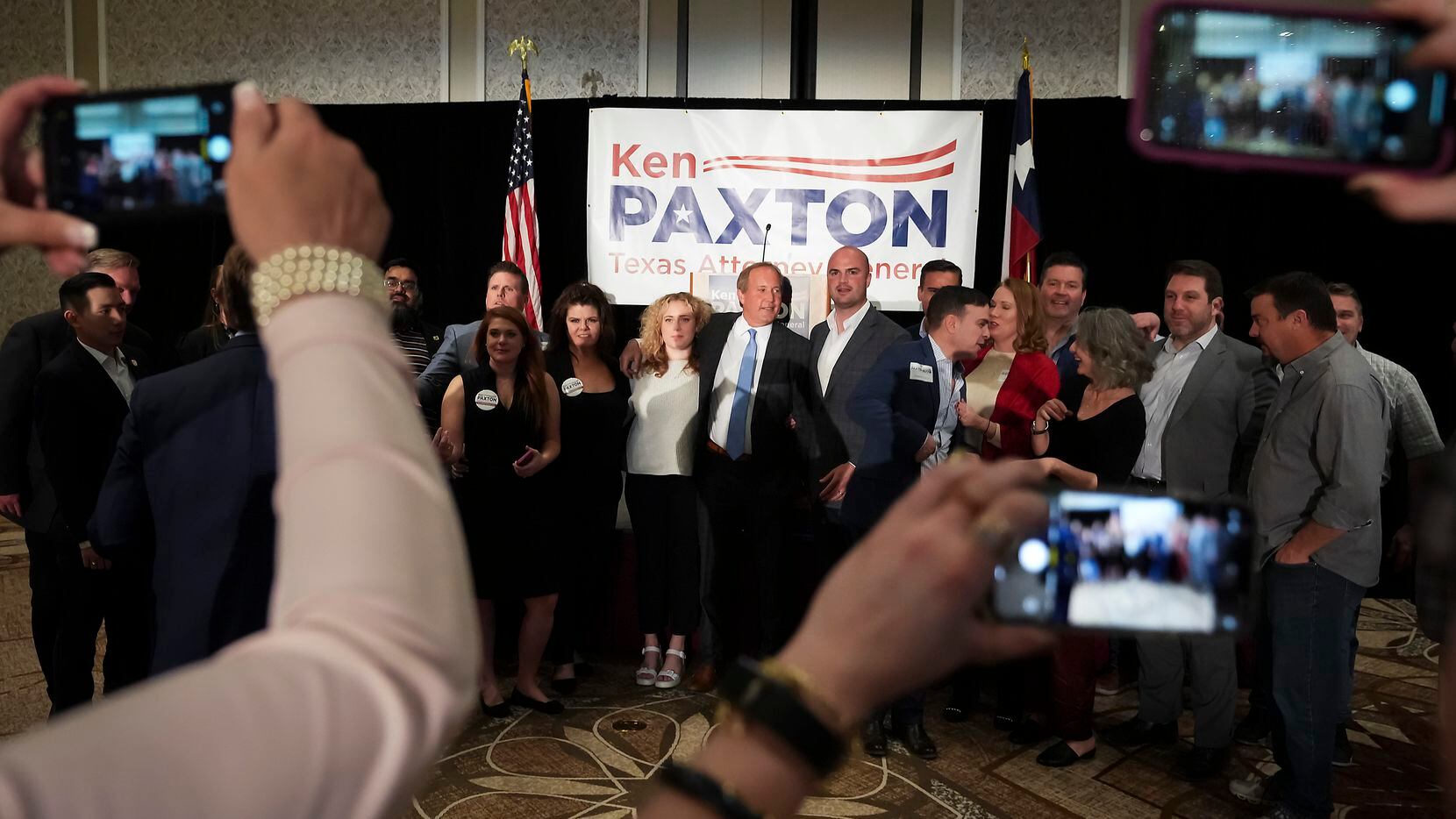 Texas Attorney General Ken Paxton poses for a photo with supporters during a primary...