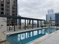 Workers put the finishing touches on a canopy on the pool deck of downtown Dallas' new JW...