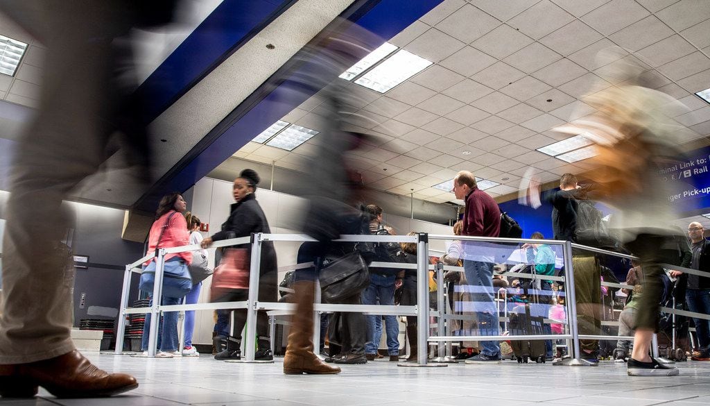Travelers made their way through Terminal C security at DFW International Airport on Dec. 21.