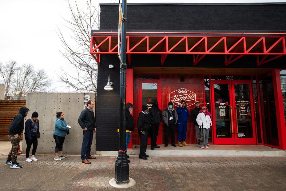 Fried chicken fans brave the cold temperatures as they wait outside of Hattie B's on its...