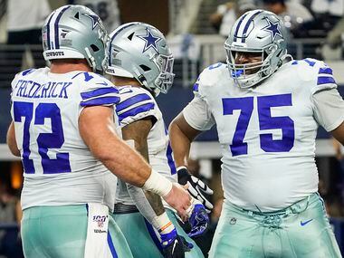 Dallas Cowboys running back Ezekiel Elliott (21) celebrates with offensive tackle Cameron Fleming (75) and center Travis Frederick (72) after scoring on a touchdown  run during the first half of an NFL football game against the Washington Redskins at AT&T Stadium on Sunday, Dec. 29, 2019, in Arlington. (Smiley N. Pool/The Dallas Morning News)