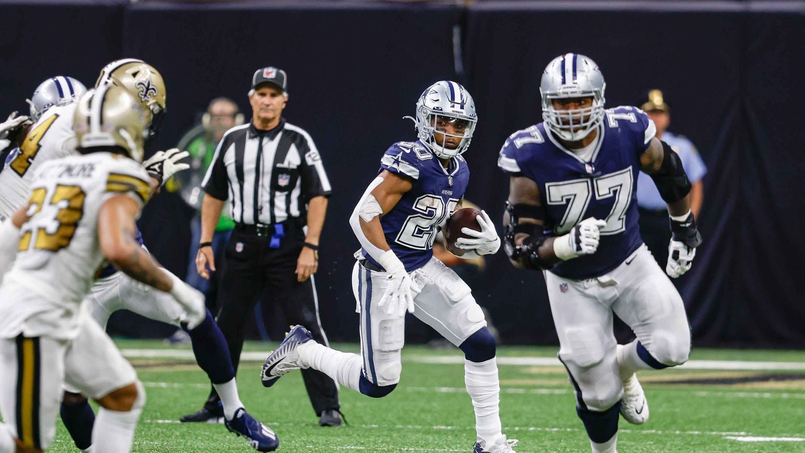 Dallas Cowboys running back Tony Pollard (20) runs with the football during the second half at the Caesars Superdome in New Orleans, Louisiana December 2, 2021.