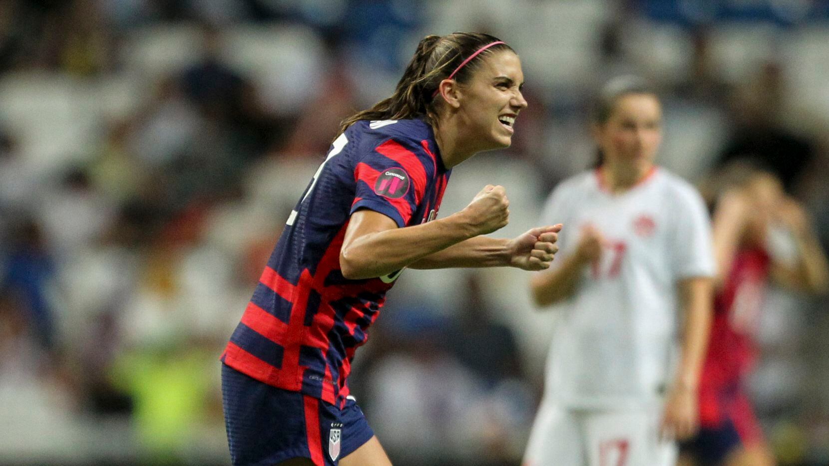 United States' Alex Morgan celebrates scoring her side's opening goal from the penalty spot...