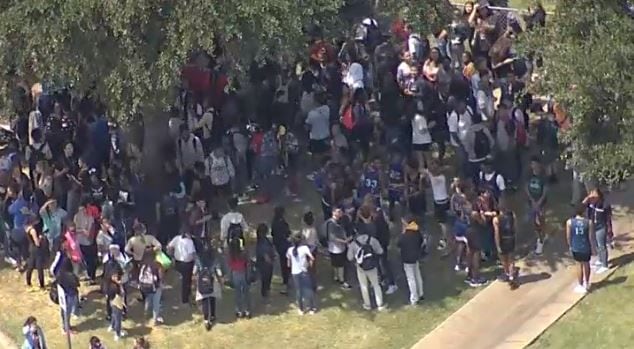 Lakeview Centennial High School students gather outside campus after smoke was reported in...