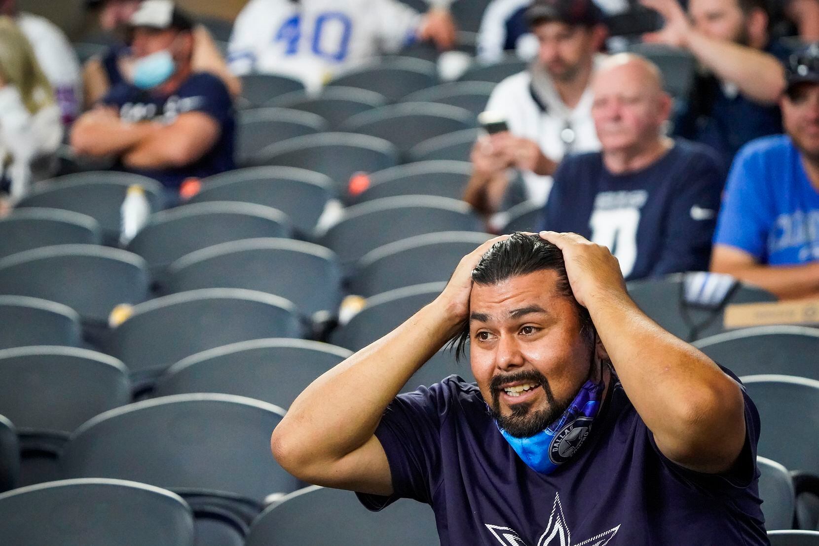 Dallas Cowboys fans Jamie Ramirez, of Amarillo, Texas, reacts after quarterback Dak Prescott was injured on a tackle by New York Giants cornerback Logan Ryan during the third quarter of an NFL football game at AT&T Stadium on Sunday, Oct. 11, 2020, in Arlington. Prescott was injured o the play when Ryan came down on his right leg and left the game. (Smiley N. Pool/The Dallas Morning News)