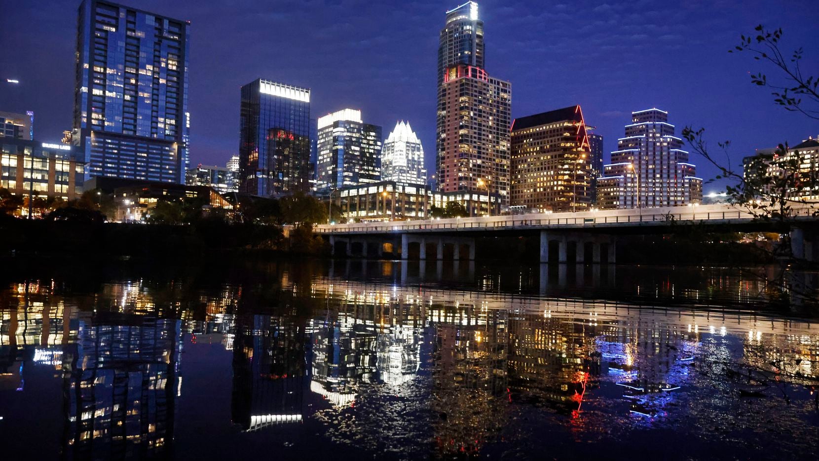 The Austin skyline  is reflected in the Colorado River at the First Street bridge downtown.