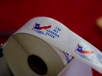 Voting stickers are seen at a political event for Texas Democratic gubernatorial candidate...