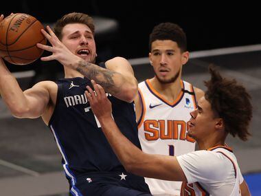 Dallas Mavericks guard Luka Doncic (77) shoots as Phoenix Suns forward Cameron Johnson (23)...
