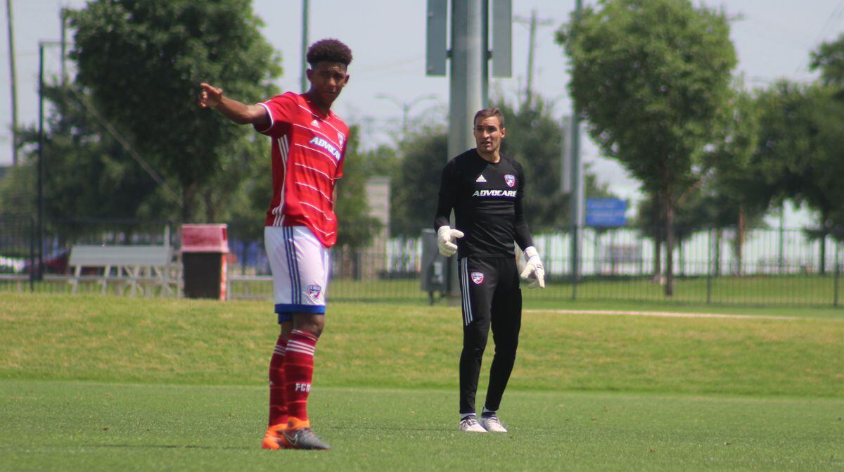 Chris Richards directs traffic against Tigres as Kyle Zobeck looks on.