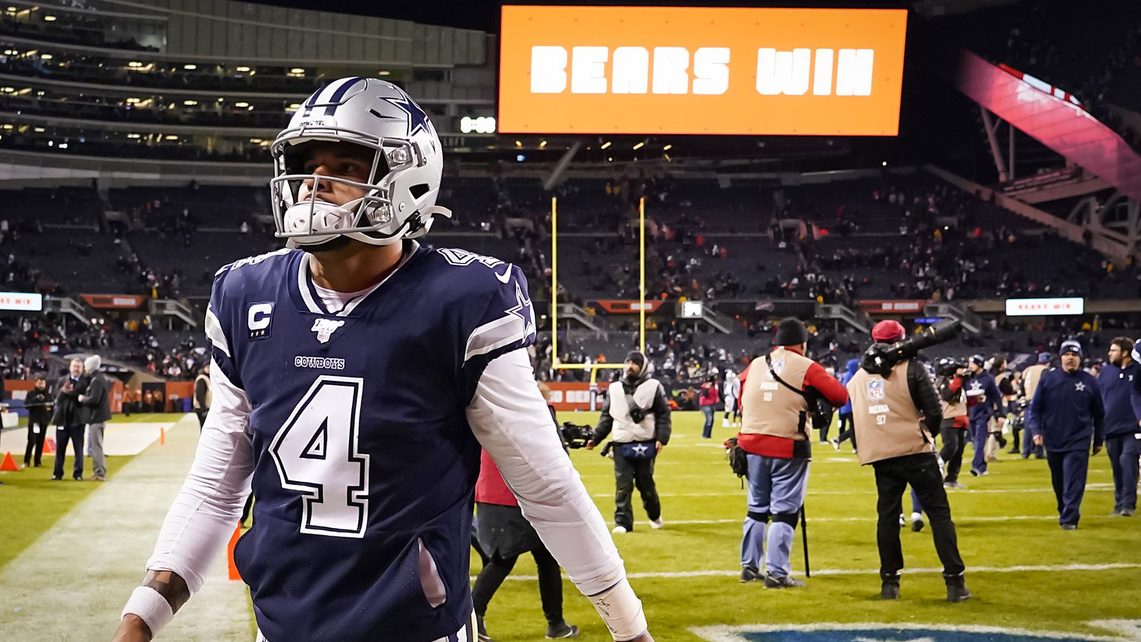 Dallas Cowboys quarterback Dak Prescott walks off the field after a loss to the Chicago Bears in an NFL football game at Soldier Field on Thursday, Dec. 5, 2019, in Chicago.