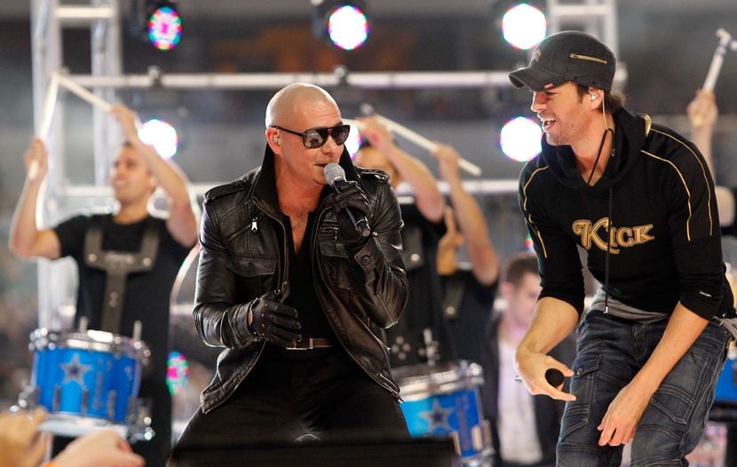 Pitbull and Enrique Iglesias sing at halftime during 2011's contest between the Dallas...
