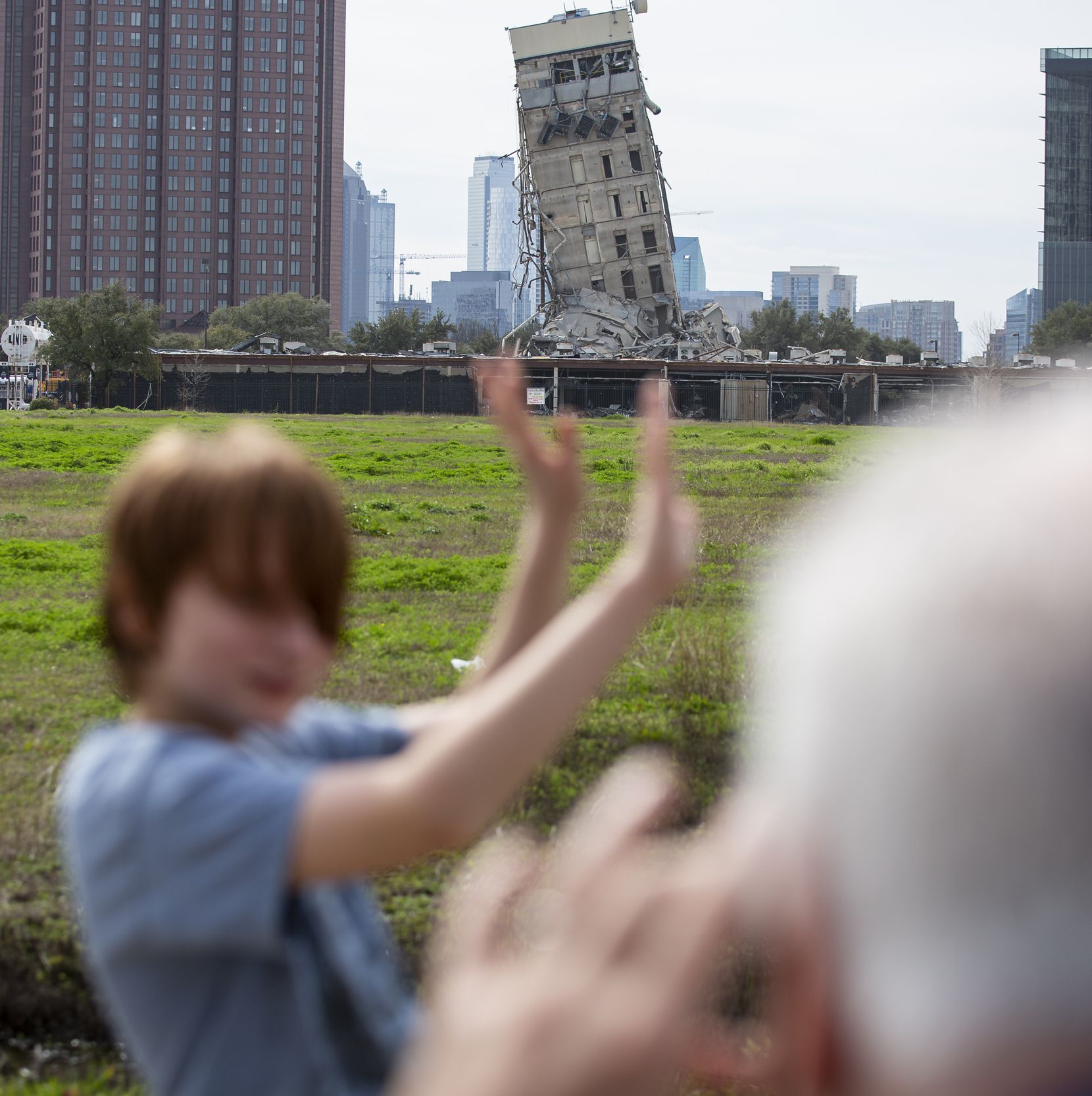 Randy Gibson takes a photo Monday of his son Andrew, 11, in front of the "Leaning Tower of Dallas."