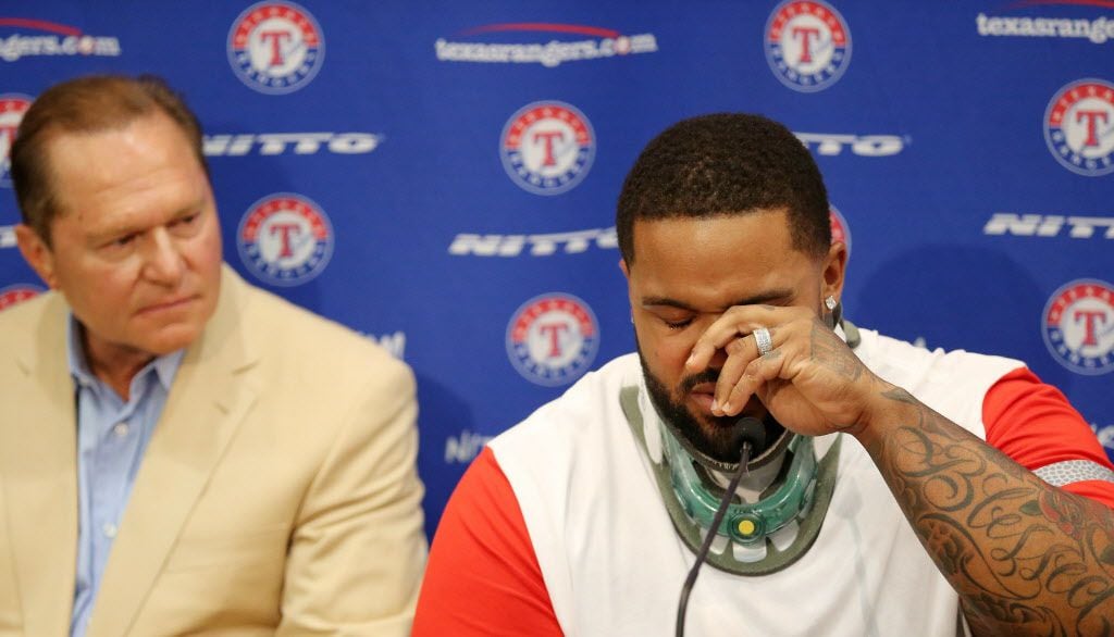 Texas Rangers designated hitter Prince Fielder wipes away a tear while speaking in a press...