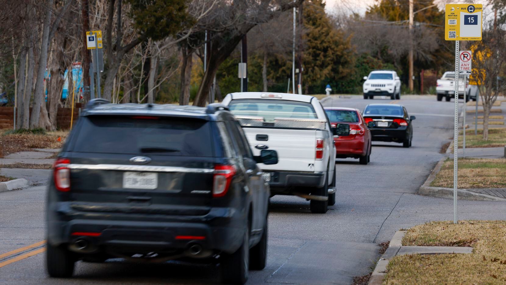A row of cars drive past a DART bus stop in Far East Dallas in February 2022.