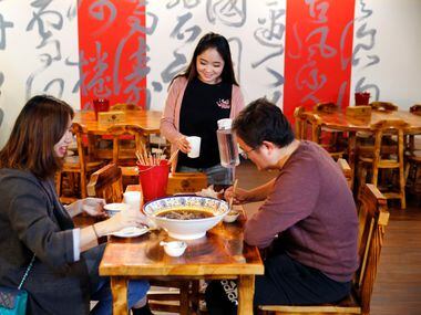 Manager Eliana Ye (center) serves diners at Chuan Chuan. (Tom Fox/Staff Photographer)