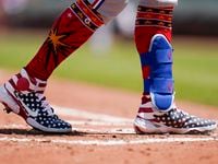 Texas Rangers' Mitch Garver wears patriotic themed cleats during the second inning of a...