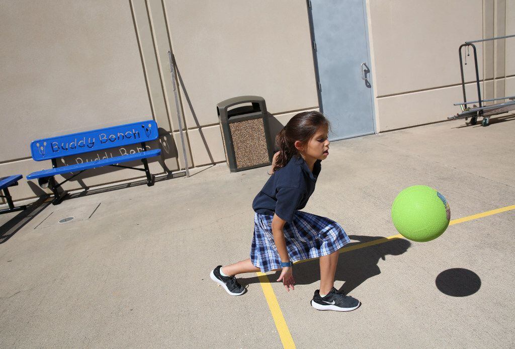 Fourth-grader Elisheva Wider plays near the Buddy Benches at Akiba Academy in North Dallas.